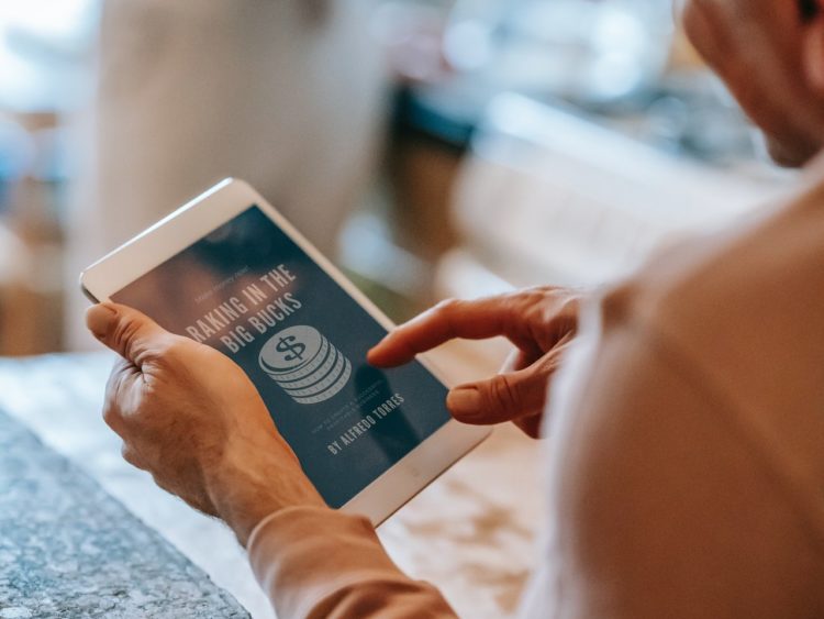 Photo by Gary  Barnes: https://www.pexels.com/photo/anonymous-man-working-remotely-on-tablet-during-breakfast-with-wife-in-kitchen-6248545/