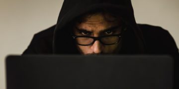 Photo by Sora Shimazaki: https://www.pexels.com/photo/crop-focused-hacker-in-hood-using-laptop-5926386/