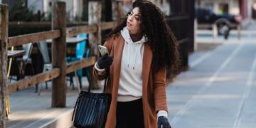 Photo by Tim Douglas : https://www.pexels.com/photo/attentive-female-carrying-shopping-bags-while-walking-with-smartphone-6567663/