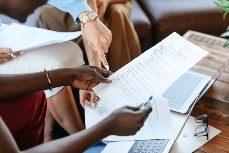 Photo by Alexander Suhorucov: https://www.pexels.com/photo/multiethnic-businesswomen-checking-information-in-documents-6457521/