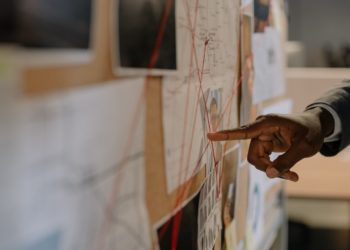 Photo by cottonbro studio: https://www.pexels.com/photo/close-up-shot-of-a-person-pointing-at-evidence-board-8369524/