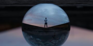 Photo by Jeremy Perkins: https://www.pexels.com/photo/round-glass-ball-reflecting-man-standing-395612/