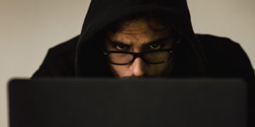 Photo by Sora Shimazaki: https://www.pexels.com/photo/crop-focused-hacker-in-hood-using-laptop-5926386/
