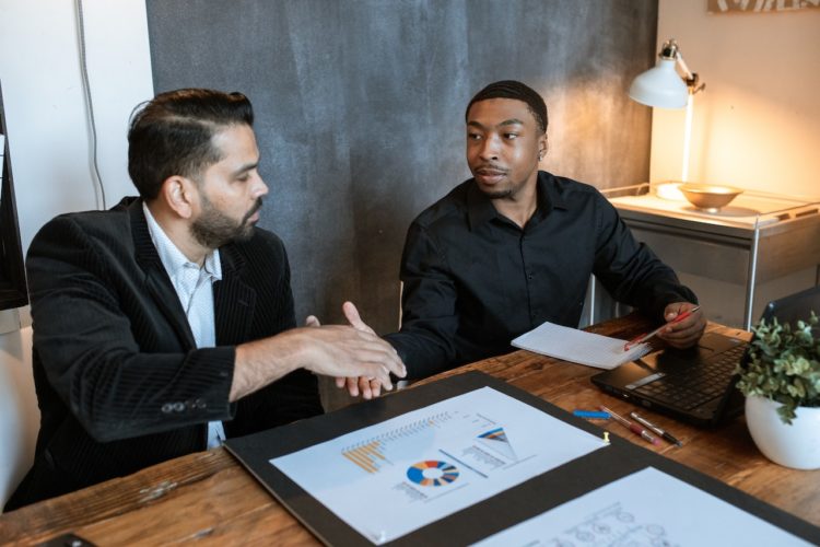 Photo by RDNE Stock project: https://www.pexels.com/photo/man-in-black-dress-shirt-sitting-beside-man-in-black-dress-shirt-5922542/
