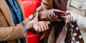 Photo by Tim Douglas : https://www.pexels.com/photo/unrecognizable-women-messaging-on-smartphones-after-shopping-in-city-6567382/