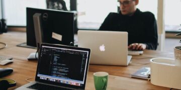Photo by Djordje Petrovic: https://www.pexels.com/photo/man-in-black-shirt-sits-behind-desk-with-computers-2102416/