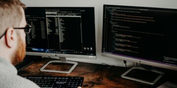 Photo by Lisa Fotios: https://www.pexels.com/photo/man-coding-on-computers-sitting-at-desk-16129703/