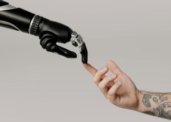 Photo by cottonbro studio from Pexels: https://www.pexels.com/photo/bionic-hand-and-human-hand-finger-pointing-6153354/