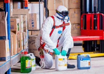 Photo by Pixabay: https://www.pexels.com/photo/person-wearing-white-suit-holding-white-container-209230/