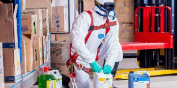 Photo by Pixabay: https://www.pexels.com/photo/person-wearing-white-suit-holding-white-container-209230/