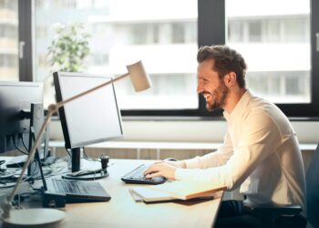 Photo by Andrea Piacquadio: https://www.pexels.com/photo/man-in-white-dress-shirt-sitting-on-black-rolling-chair-while-facing-black-computer-set-and-smiling-840996/