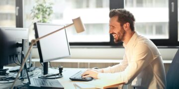 Photo by Andrea Piacquadio: https://www.pexels.com/photo/man-in-white-dress-shirt-sitting-on-black-rolling-chair-while-facing-black-computer-set-and-smiling-840996/