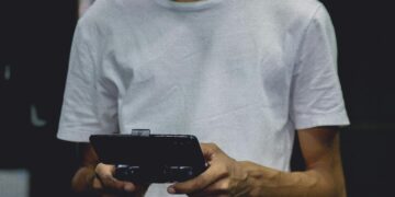 Photo by Nino Souza: https://www.pexels.com/photo/a-smartphone-game-controller-on-a-person-s-hand-2883029/