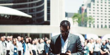 Photo by Yama Saighani: https://www.pexels.com/photo/selective-focus-photography-of-man-holding-smartphone-while-standing-near-people-624367/