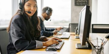 Photo by Yan Krukau: https://www.pexels.com/photo/a-smiling-woman-working-in-a-call-center-while-looking-at-camera-8867434/