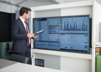 Photo by Kampus Production: https://www.pexels.com/photo/man-in-corporate-attire-looking-at-a-wide-screen-monitor-8353796/