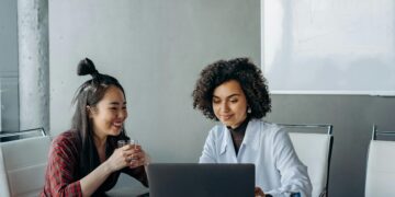 Photo by Mikhail Nilov: https://www.pexels.com/photo/women-having-a-conversation-while-looking-at-the-screen-of-a-laptop-8297687/