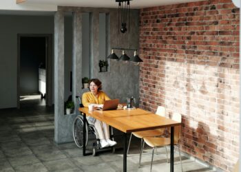 Photo by Marcus Aurelius: https://www.pexels.com/photo/a-woman-wearing-orange-long-sleeves-on-a-wheel-chair-beside-a-wooden-table-using-a-laptop-4064698/