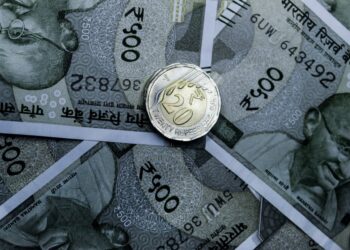 Photo by Ravi Roshan: https://www.pexels.com/photo/a-coin-on-cash-notes-14907356/