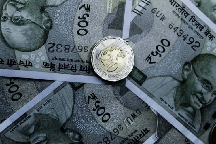 Photo by Ravi Roshan: https://www.pexels.com/photo/a-coin-on-cash-notes-14907356/