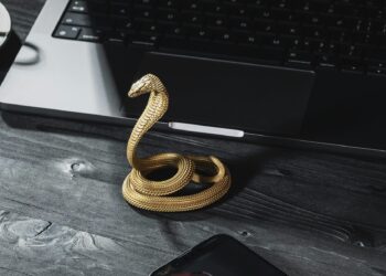 Photo by COPPERTIST WU from Pexels: https://www.pexels.com/photo/a-handmade-golden-cobra-phone-stand-standing-next-to-a-laptop-and-smartphone-15979673/