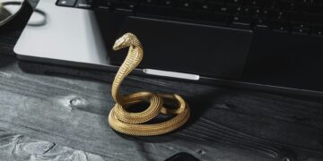 Photo by COPPERTIST WU from Pexels: https://www.pexels.com/photo/a-handmade-golden-cobra-phone-stand-standing-next-to-a-laptop-and-smartphone-15979673/