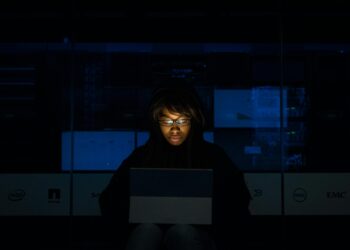 Photo by Christina Morillo: https://www.pexels.com/photo/woman-wearing-black-hoodie-jacket-holding-grey-laptop-computer-1181325/ IT