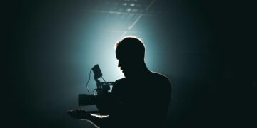 Photo by Kyle Loftus: https://www.pexels.com/photo/silhouette-of-man-standing-in-front-of-microphone-3379934/