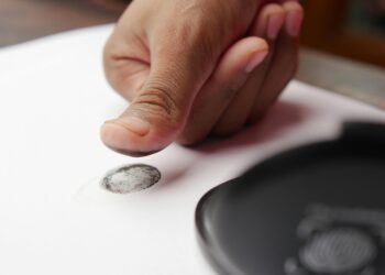 Photo by Towfiqu barbhuiya: https://www.pexels.com/photo/a-person-putting-a-fingerprint-on-a-white-paper-12375509/