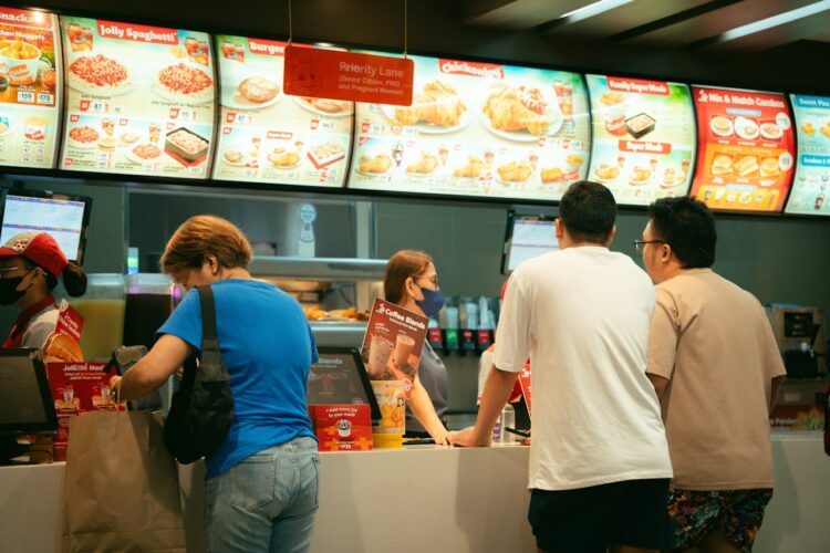 Photo by Kenneth Surillo: https://www.pexels.com/photo/people-standing-in-line-at-a-fast-food-restaurant-27299962/