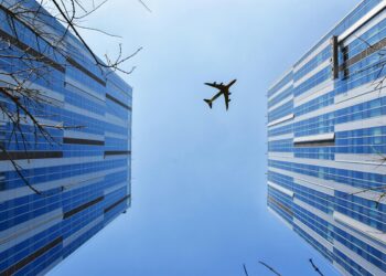 Photo by 周 康: https://www.pexels.com/photo/airplane-near-blue-and-grey-building-747079/