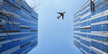 Photo by 周 康: https://www.pexels.com/photo/airplane-near-blue-and-grey-building-747079/