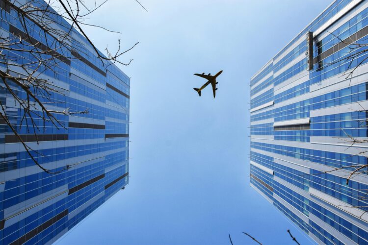 Photo by 周 康: https://www.pexels.com/photo/airplane-near-blue-and-grey-building-747079/